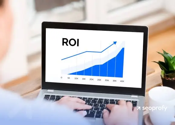 A laptop screen displaying an upward-trending graph labeled "ROI."